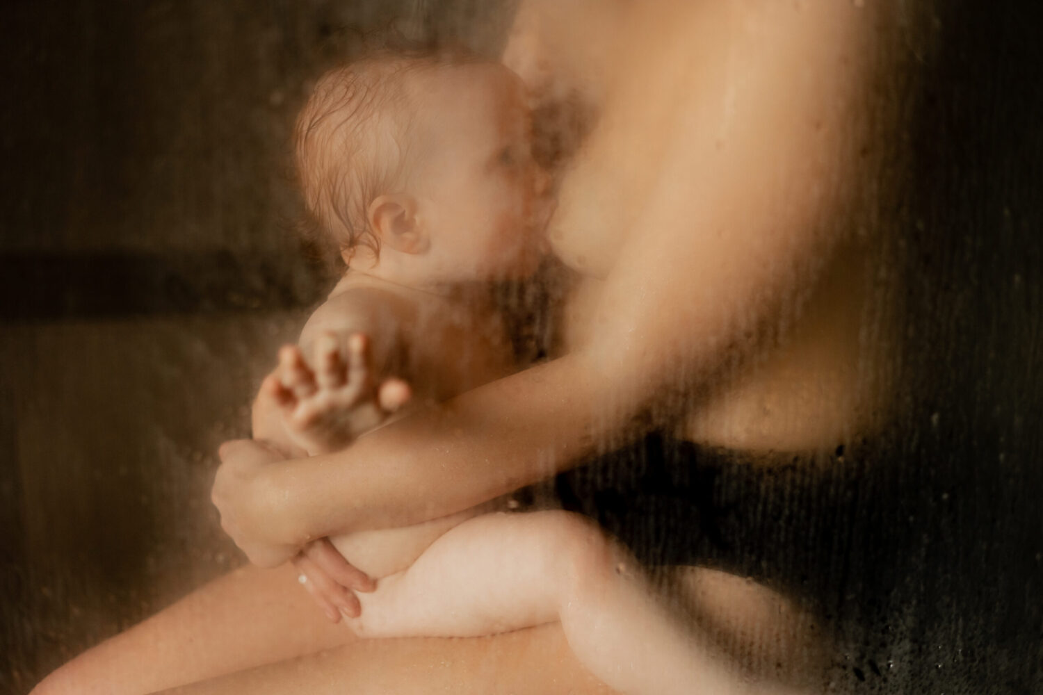 baby breastfeeding in the shower for a raw motherhood photography session in Seattle