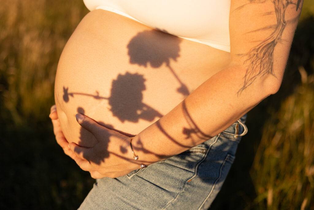 Pregnant belly with flower shadows for a maternity session in Seattle