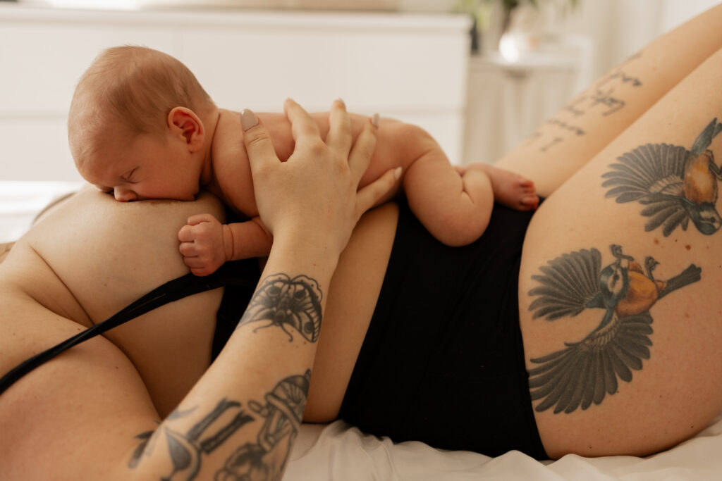 Baby breastfeeding during in home newborn photography session in Seattle