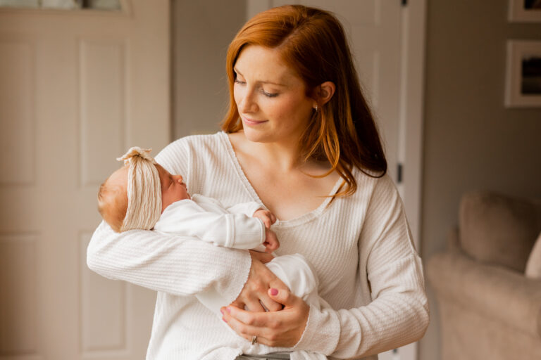 Mother holds baby during her in home newborn photography session in Lake Stevens, WA