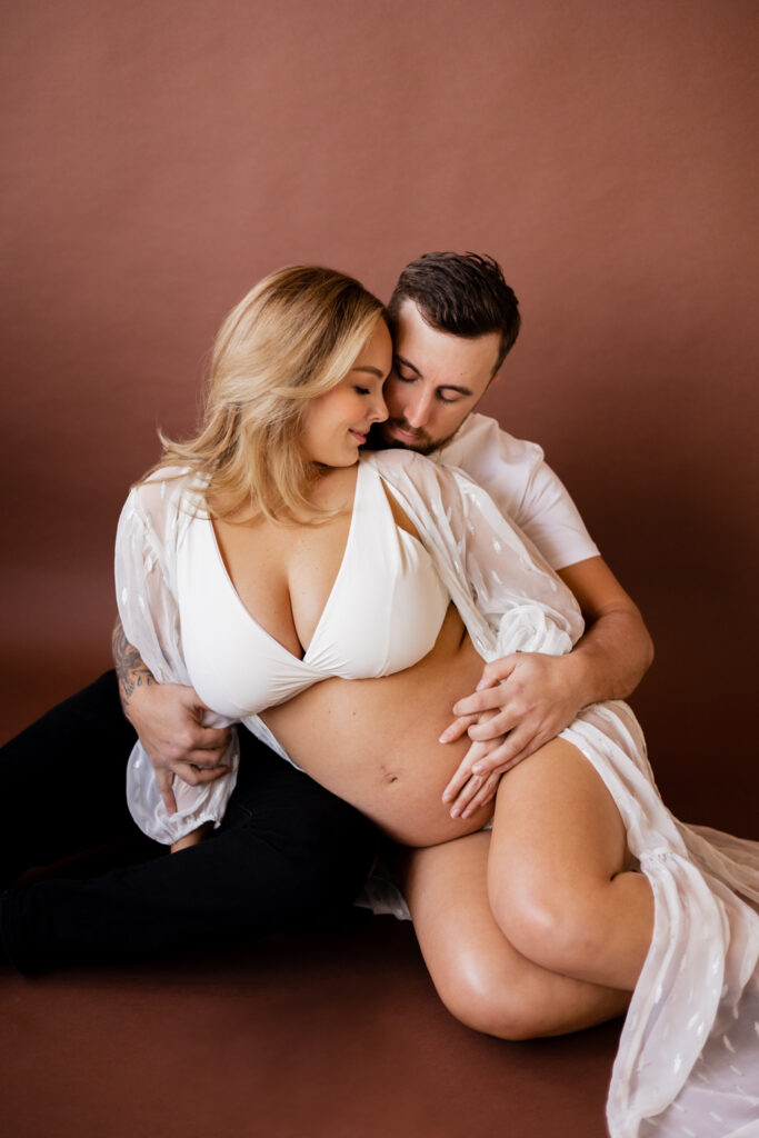 Boudoir maternity photography session in studio with husband and wife in North Seattle