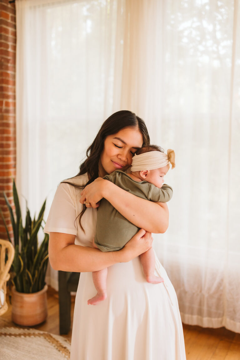 In home newborn session in Seattle with mom holding baby