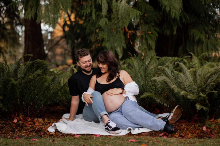 Couple hugging at Seattle arboretum for maternity photoshoot